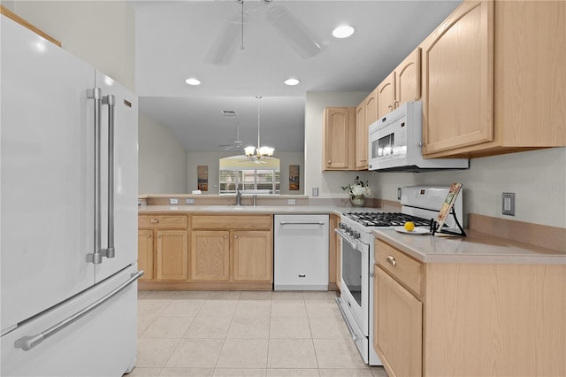 kitchen with light brown cabinetry, sink, white appliances, light tile patterned floors, and ceiling fan