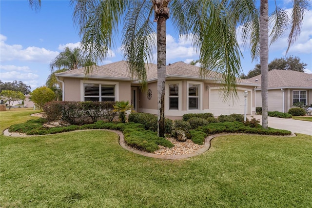 ranch-style home with a garage and a front lawn