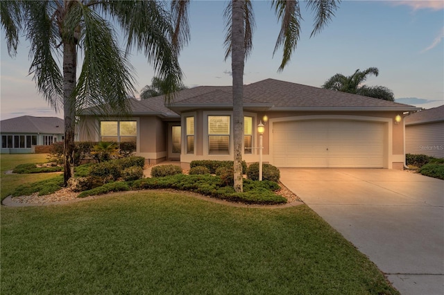 view of front facade featuring a garage and a yard