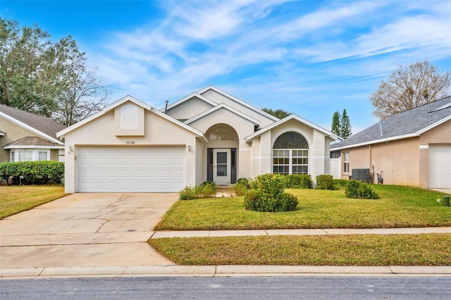 ranch-style home with a garage and a front yard