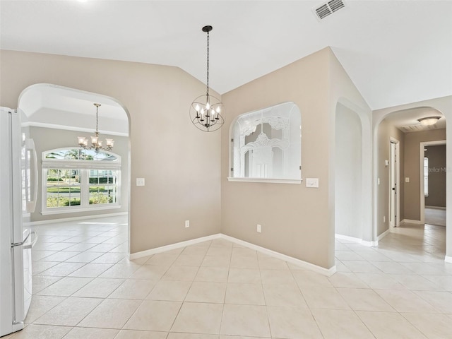 tiled spare room with vaulted ceiling and a notable chandelier