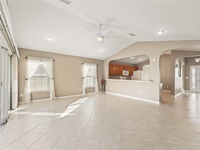 unfurnished living room featuring ceiling fan, light tile patterned floors, and lofted ceiling