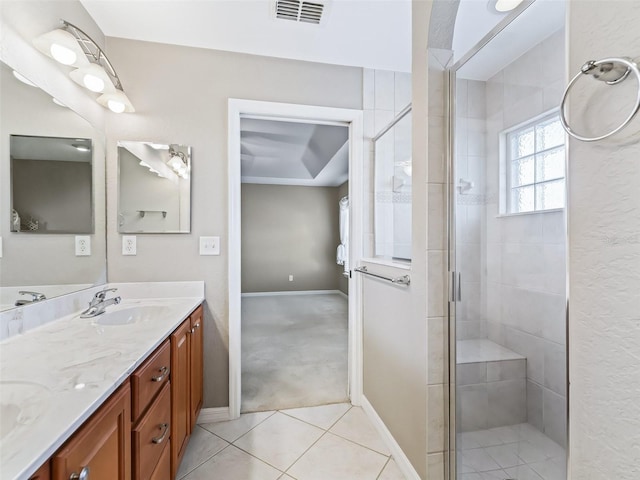 bathroom featuring tile patterned floors, walk in shower, and vanity