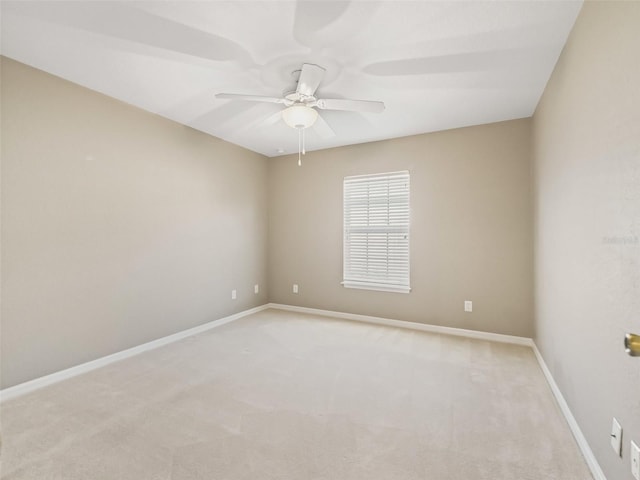 spare room with light carpet and ceiling fan