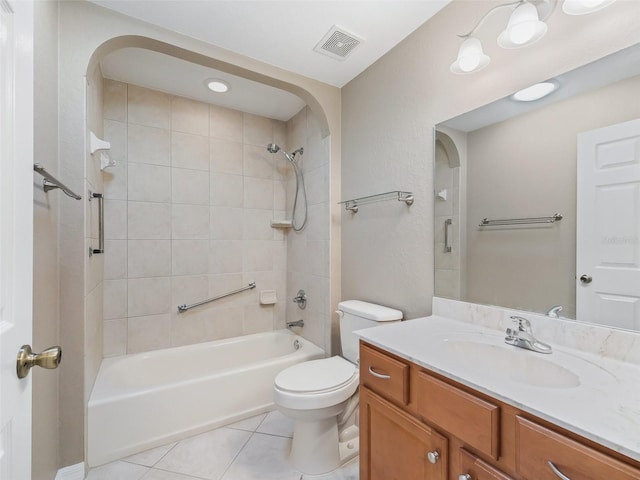 full bathroom featuring toilet, tile patterned flooring, tiled shower / bath combo, and vanity