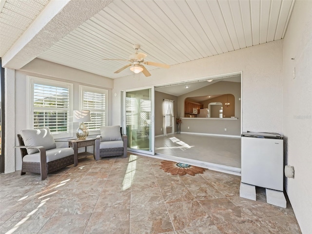 unfurnished sunroom featuring ceiling fan