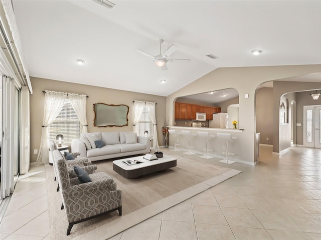 tiled living room featuring vaulted ceiling and ceiling fan