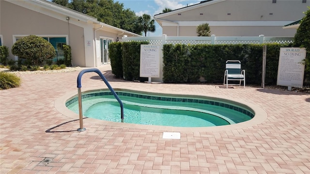 view of swimming pool with a community hot tub