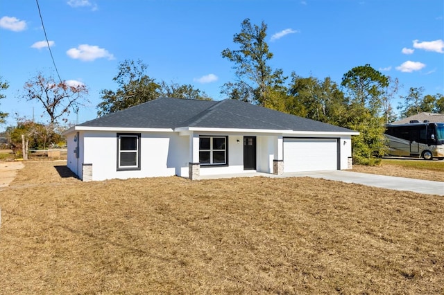 single story home with a garage and a front lawn