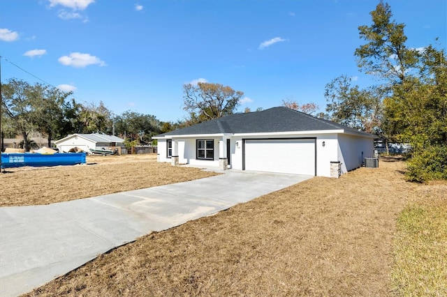 single story home featuring a front yard, cooling unit, and a garage