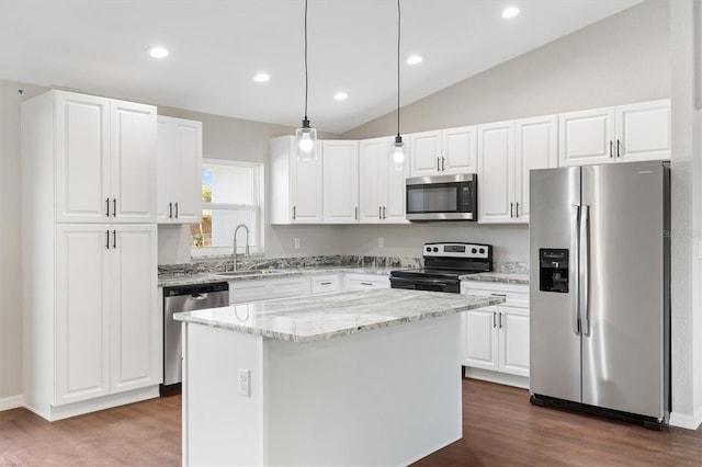 kitchen featuring pendant lighting, appliances with stainless steel finishes, a center island, white cabinetry, and sink