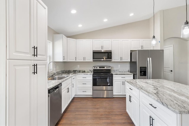 kitchen with white cabinetry, appliances with stainless steel finishes, lofted ceiling, hanging light fixtures, and sink