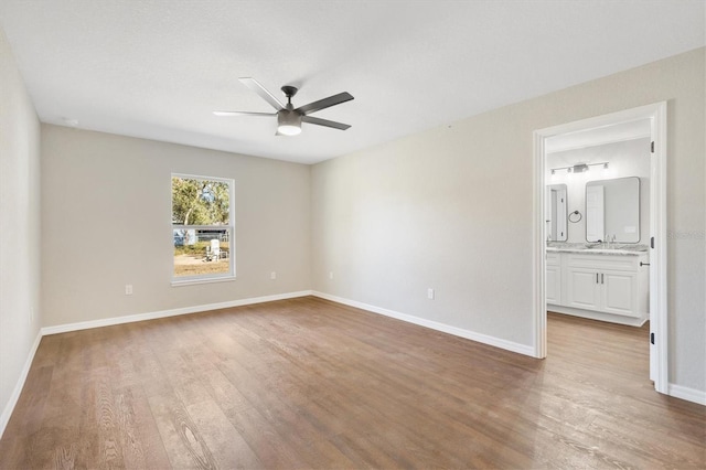 empty room with ceiling fan and wood-type flooring