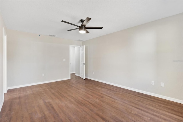 spare room featuring ceiling fan and dark hardwood / wood-style flooring