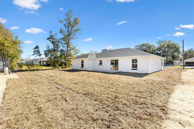 back of property with a lawn