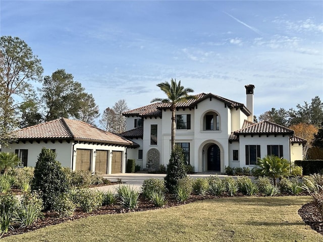 view of front of house featuring a garage and a front lawn