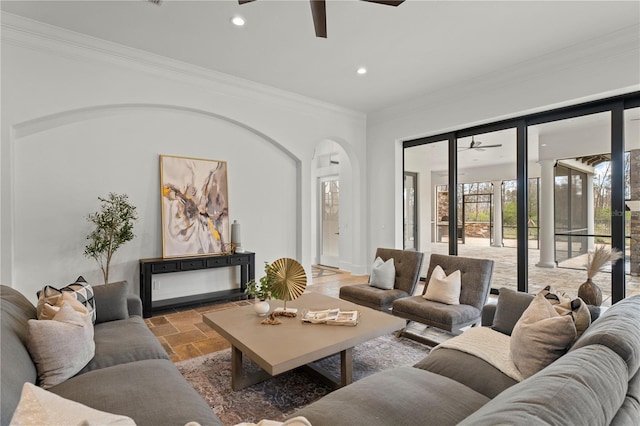 living room with crown molding and ceiling fan