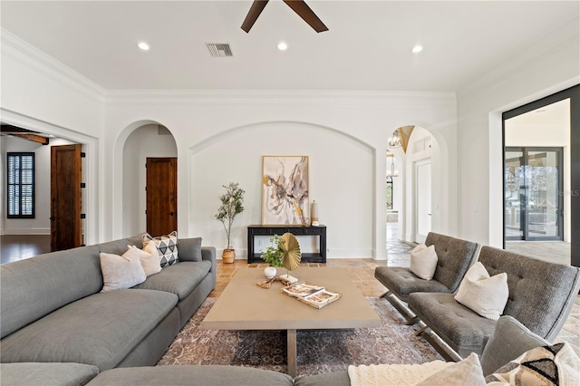 living room with plenty of natural light, ceiling fan, and ornamental molding