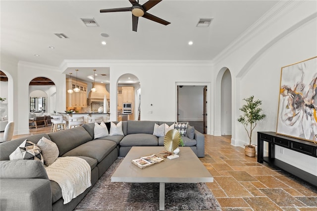 living room with ceiling fan and crown molding