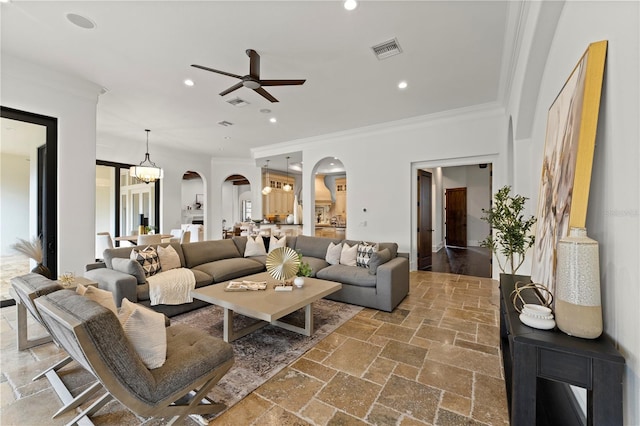 living room with ceiling fan and crown molding