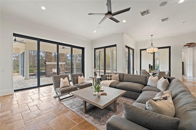 living room with crown molding and ceiling fan