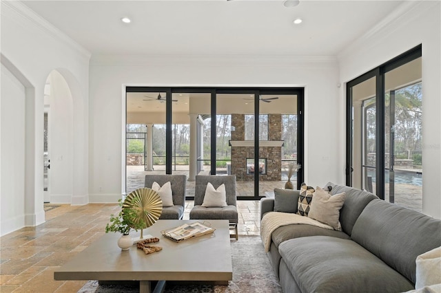 living room with crown molding and a healthy amount of sunlight