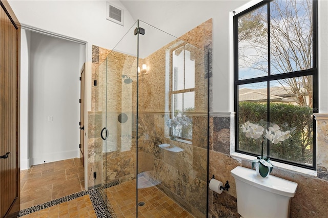 bathroom with toilet and walk in shower