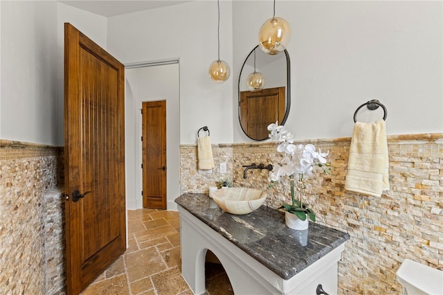 bathroom featuring tile walls and vanity