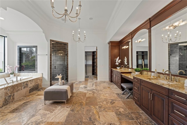 bathroom with separate shower and tub, vanity, crown molding, and an inviting chandelier