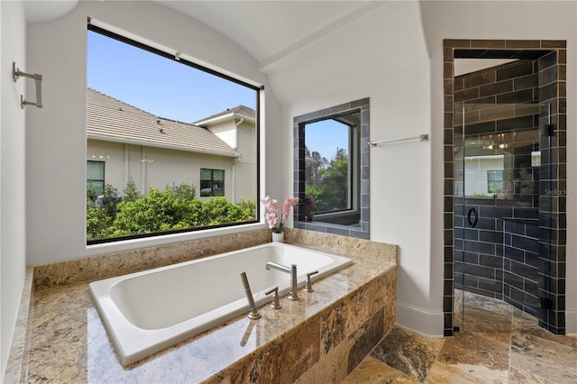 bathroom featuring separate shower and tub