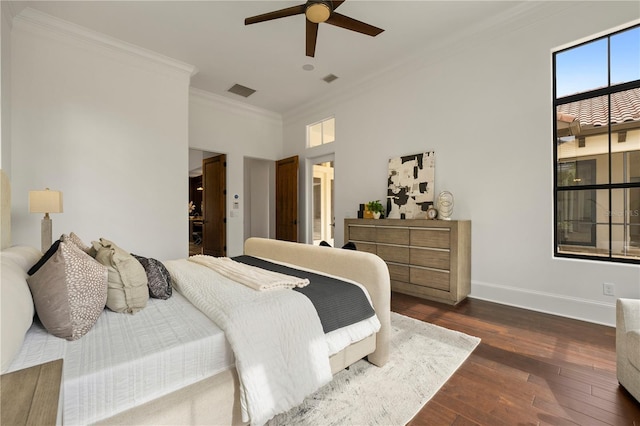 bedroom featuring ceiling fan, dark hardwood / wood-style flooring, a high ceiling, and ornamental molding