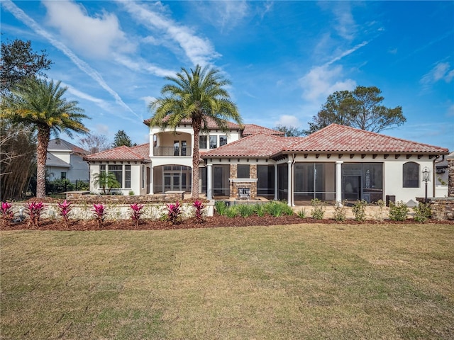 rear view of property featuring a yard and a balcony