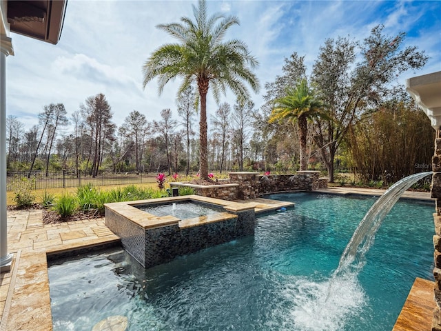 view of pool featuring an in ground hot tub and pool water feature