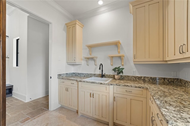 kitchen featuring ornamental molding, sink, light brown cabinetry, and stone countertops