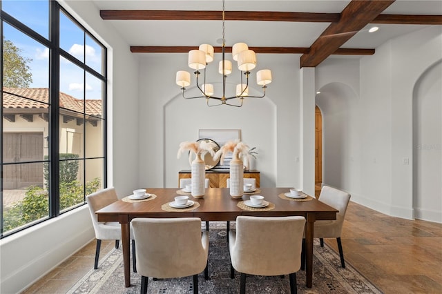 dining room featuring a notable chandelier and beam ceiling