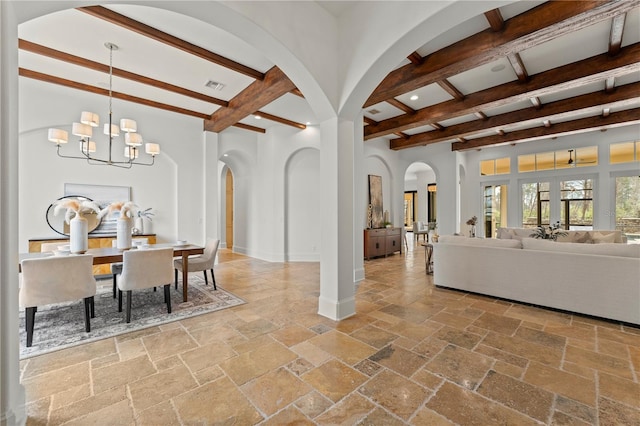 dining room featuring a notable chandelier and beam ceiling