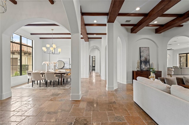 interior space with beamed ceiling and a notable chandelier