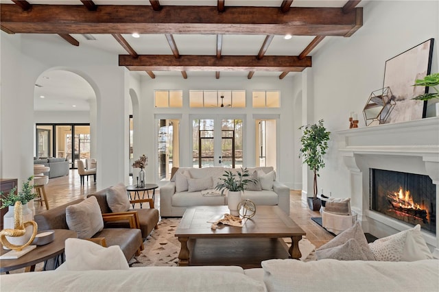 living room with french doors and beamed ceiling