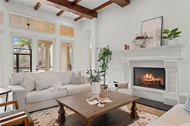 living room featuring french doors and beamed ceiling