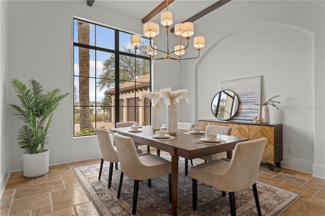 dining area with a chandelier and a high ceiling