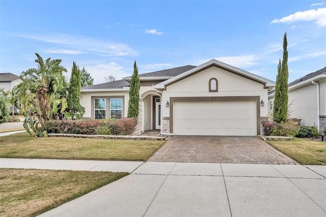 ranch-style home with a front yard and a garage