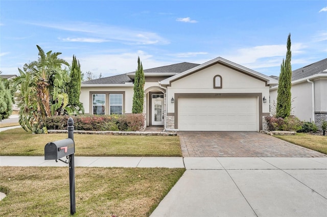 single story home with a front yard and a garage