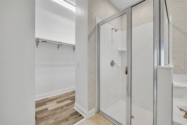 bathroom with wood-type flooring and walk in shower