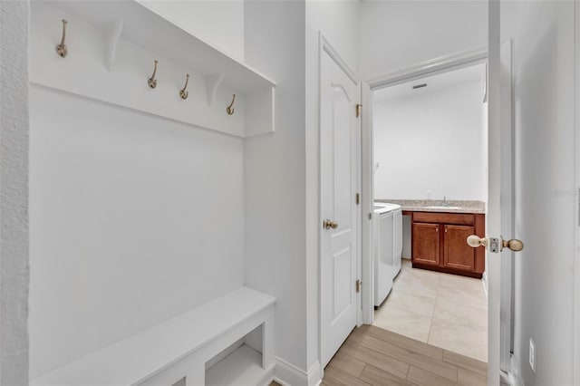 mudroom with washer and clothes dryer