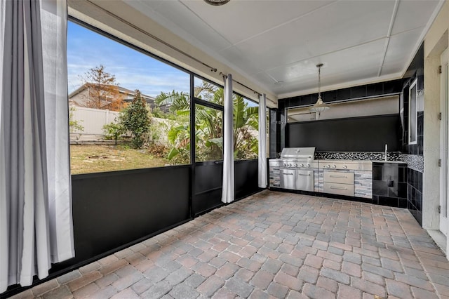 unfurnished sunroom with sink