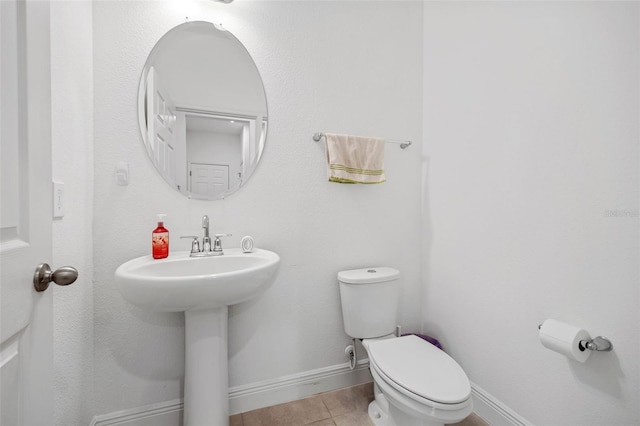 bathroom featuring sink, tile patterned floors, and toilet