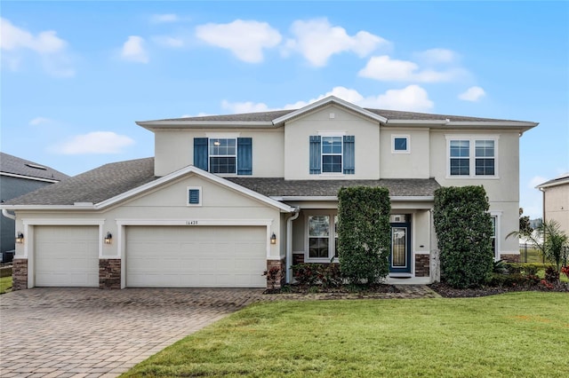 view of front of home featuring a garage and a front lawn