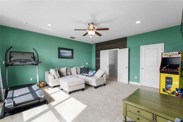 carpeted living room with ceiling fan