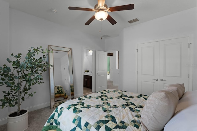 bedroom with ceiling fan, light colored carpet, ensuite bath, and a closet