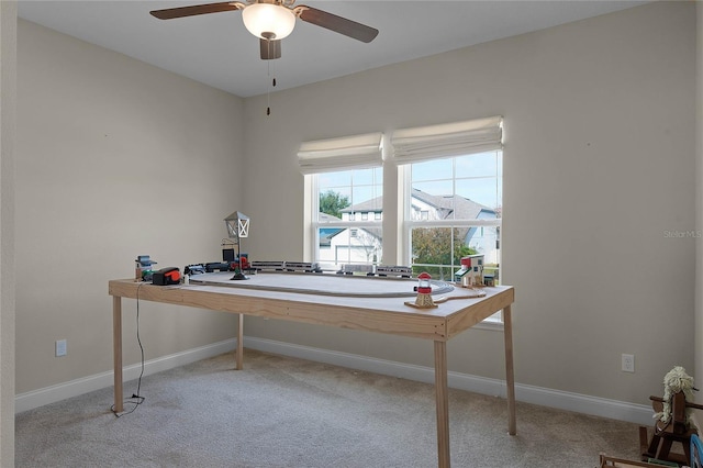 office space featuring ceiling fan and light colored carpet